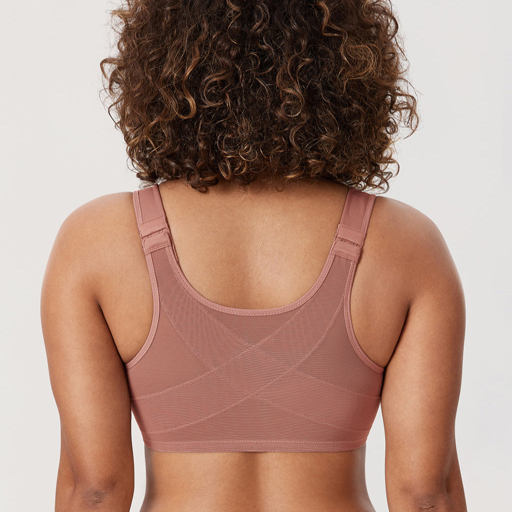 Person wearing a brown sports bra and leggings on a white background