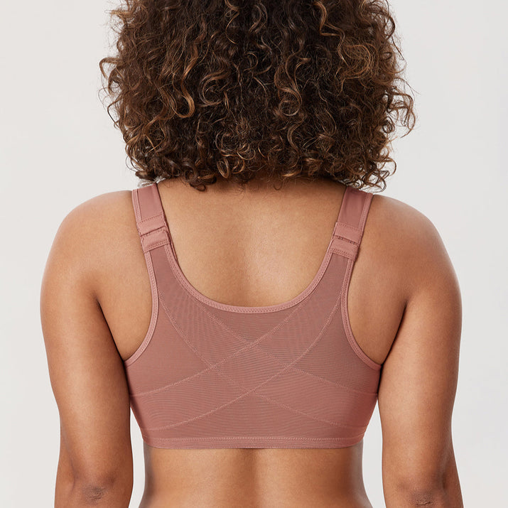 Person wearing a brown sports bra and leggings on a white background